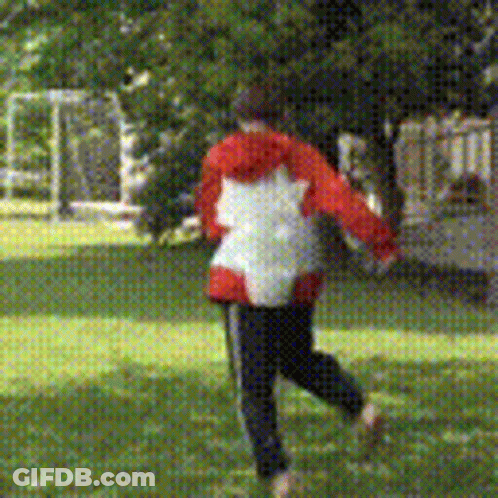 Person In Red And White Jacket Running In Grass GIF