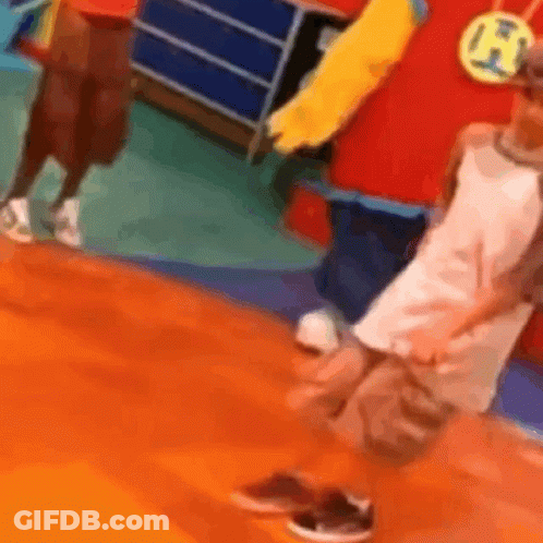 Person In Red And Yellow Costume Beside Child In White GIF