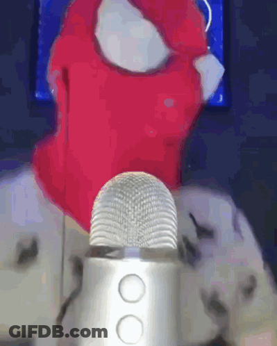 Person In Red Balaclava Talking Into Microphone GIF
