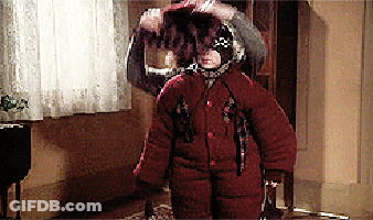 Person In Red Coat Standing In Hallway GIF