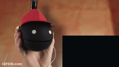 Person In Red Hat Holding Black Ball With Face GIF