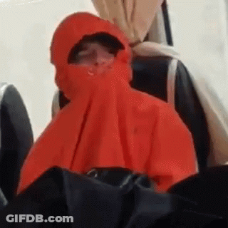 Person In Red Hooded Jacket Sitting On Chair GIF