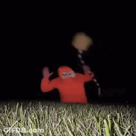 Person In Red Hoodie Standing In Grass GIF