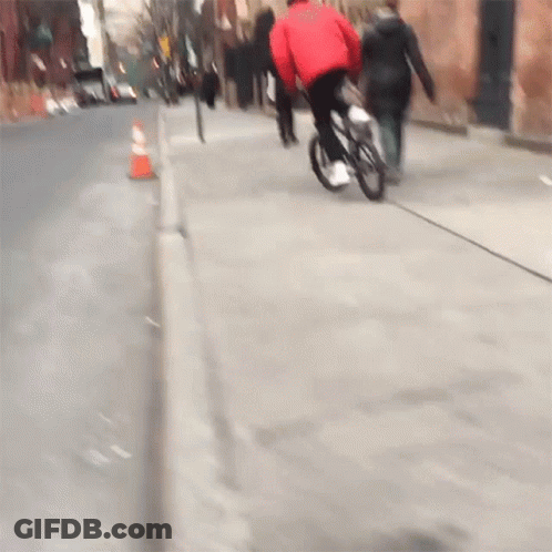 Person In Red Jacket Riding Bike GIF
