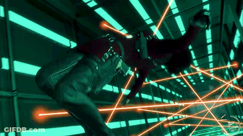 Person In Red Shirt Surrounded By Green And Orange Lights GIF
