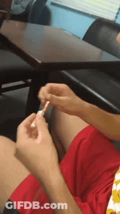 Person In Red Shorts Sitting At Table GIF