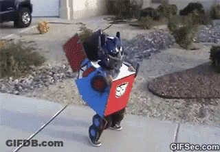 Person In Robot Costume Walking Down Sidewalk GIF