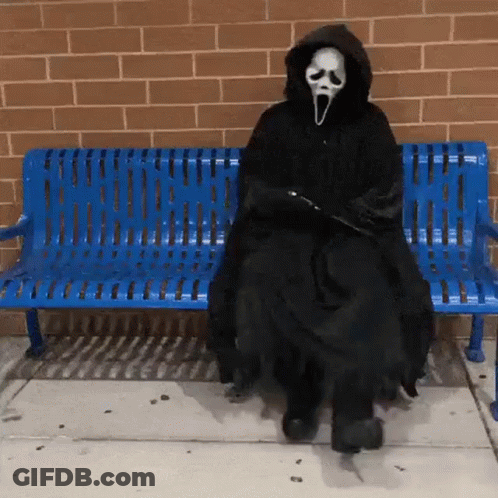 Person In Scream Costume Sitting On Blue Bench GIF