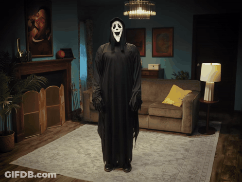Person In Scream Costume Standing In Living Room GIF