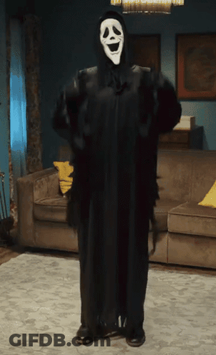 Person In Scream Costume Standing In Living Room GIF