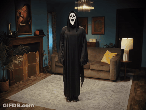 Person In Scream Costume Standing In Living Room GIF