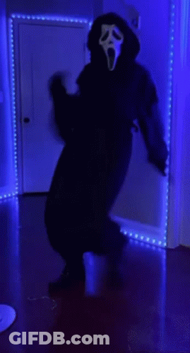 Person In Scream Mask In Dark Room GIF