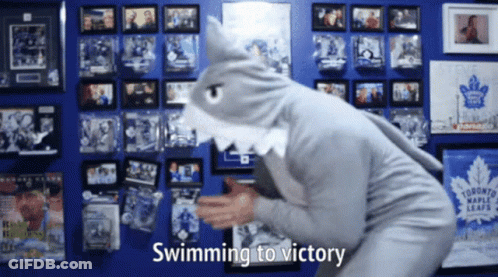 Person In Shark Costume Swimming To Victory GIF