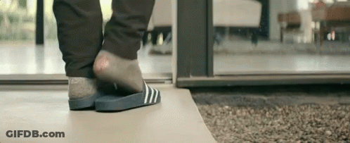 Person In Slippers Standing On Tile Floor GIF