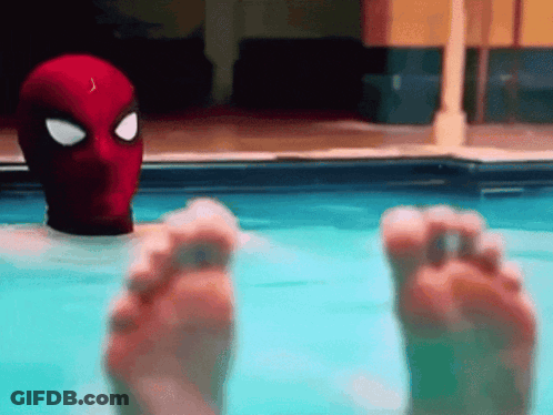 Person In Spiderman Mask Floating In Pool GIF