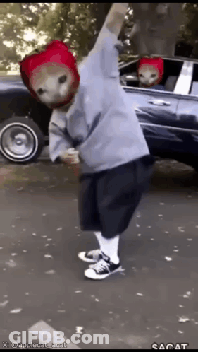 Person In Strawberry Hat Standing In Front Of Car GIF