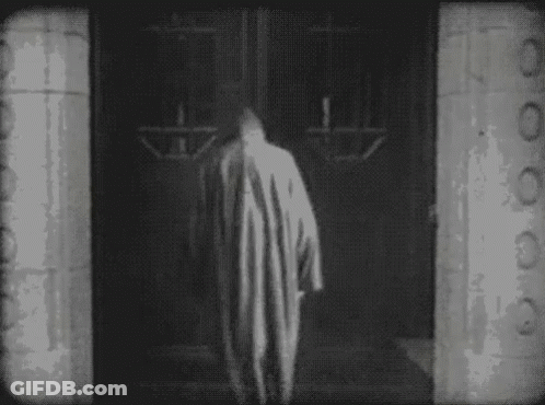 Person In Striped Robe Walking Through Doorway GIF