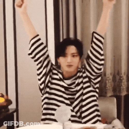 Person In Striped Shirt With Arms Up GIF