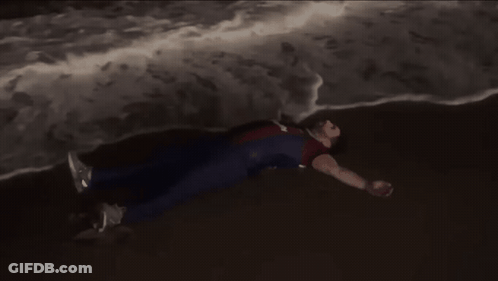 Person In Superhero Costume Lying On Ground GIF