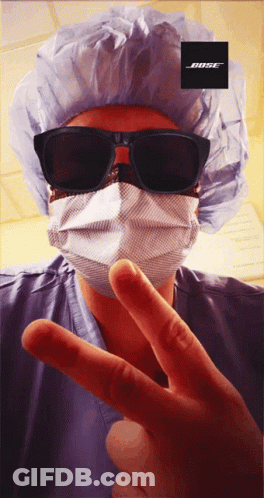 Person In Surgical Mask And Sunglasses With Bose Logo GIF