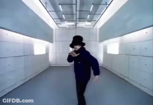 Person In Top Hat Dancing In Hallway GIF