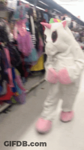 Person In Unicorn Costume Walking Down Store Aisle GIF