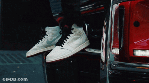 Person In White Nike Sneakers Sitting On Red Car GIF