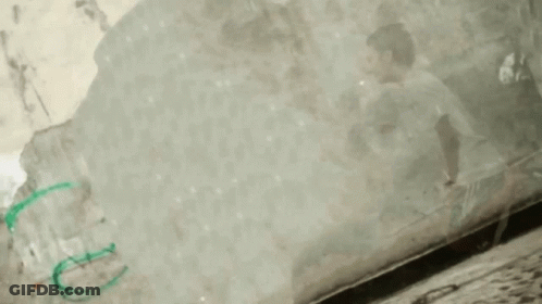 Person In White Shirt Green Shorts Flying With Stick GIF