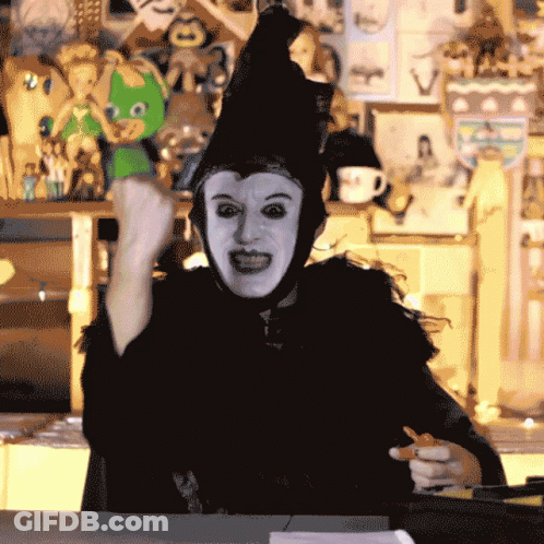 Person In Witch Costume Holding Pen GIF