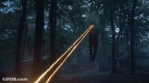 Person In Woods With Light From Hands GIF