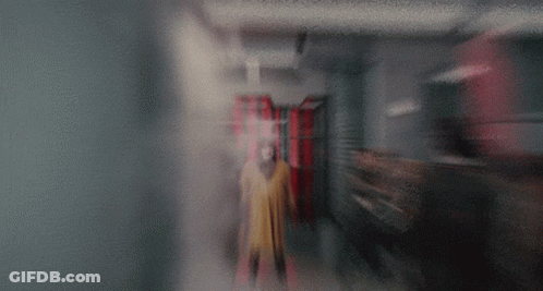 Person In Yellow Coat GIF