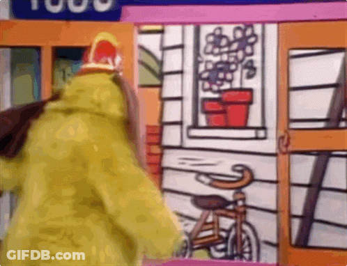 Person In Yellow Coat With Bicycle And House GIF