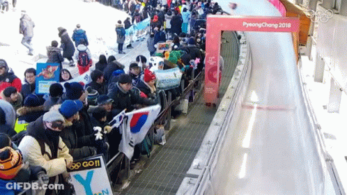 Person In Yellow Fila Shirt Kneeling On Sled GIF