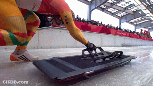 Person In Yellow Fila Shirt Kneeling On Sled GIF