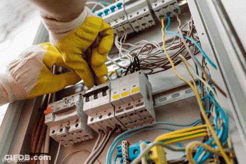 Person In Yellow Gloves Working On Electrical Box GIF