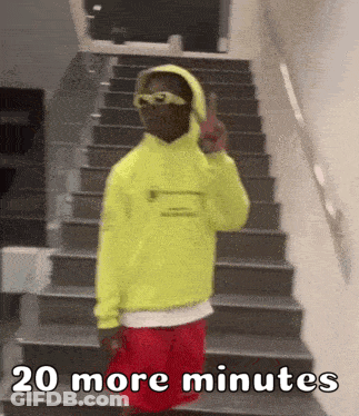 Person In Yellow Hoodie And Red Shorts On Stairs GIF