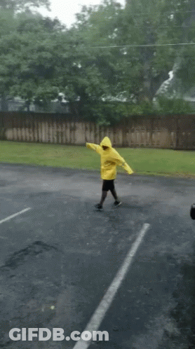 Person In Yellow Raincoat Dancing GIF