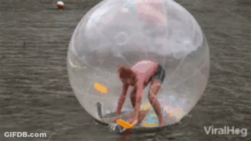 Person Inside Clear Ball Floating In Water GIF
