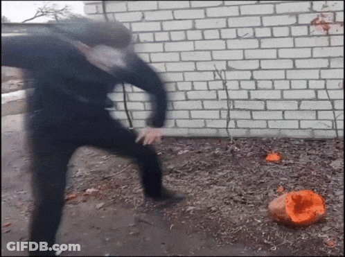 Person Kicking Pumpkin In Dirt GIF