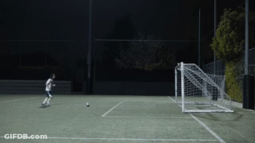 Person Kicking Soccer Ball Into Goal GIF