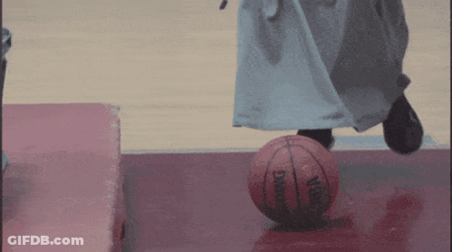 Person Kicking Spalding Basketball On Court GIF