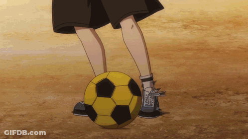 Person Kicking Yellow And Black Soccer Ball On Dirt Field GIF