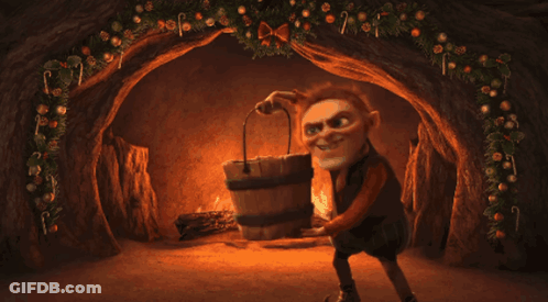 Person Kneeling In Front Of Fireplace With Candy Canes GIF