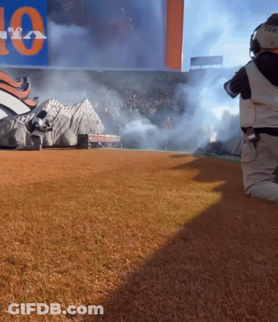 Person Kneeling In Front Of Sign That Says 10 GIF