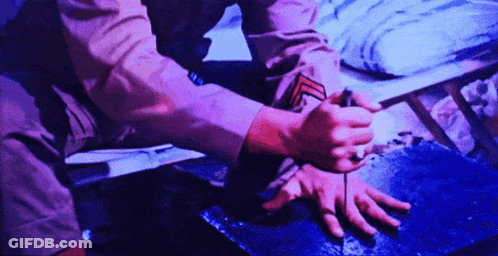 Person Kneeling In Purple Shirt GIF