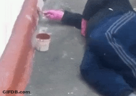 Person Kneeling Painting Wall With Brush GIF