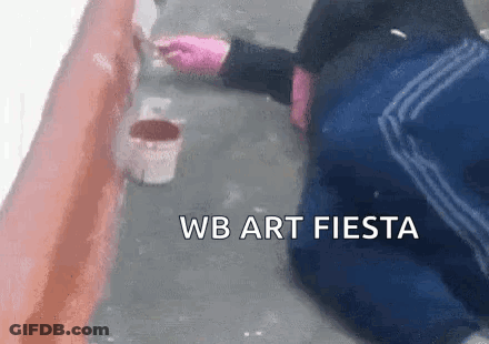 Person Kneeling While Painting Wall With Brush GIF