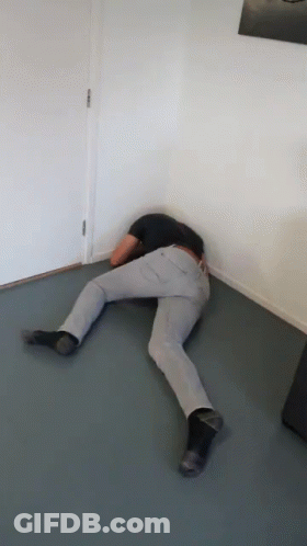 Person Laying Floor Head In Corner GIF