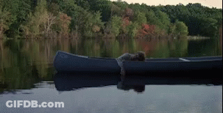 Person Laying In Canoe On Lake GIF