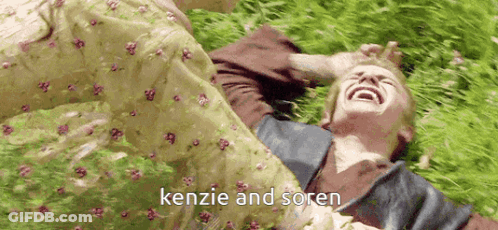 Person Laying In Grass With Kenzie And Soren GIF